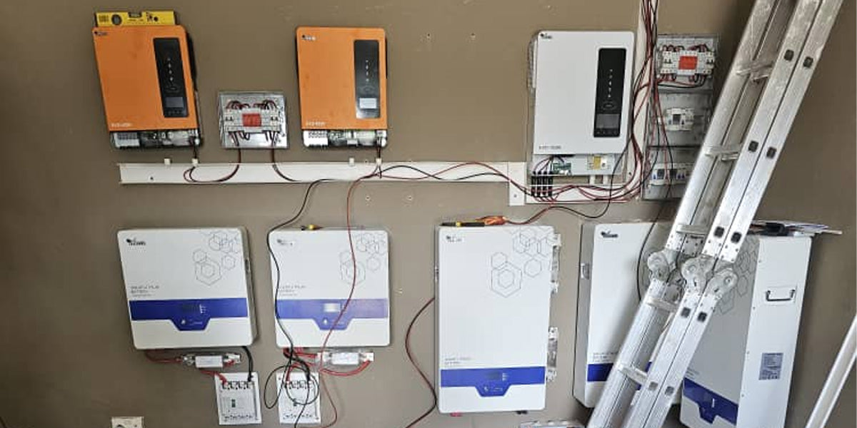 An interior wall installation showing two Anern EVO series inverters and multiple lithium battery packs with organized wiring