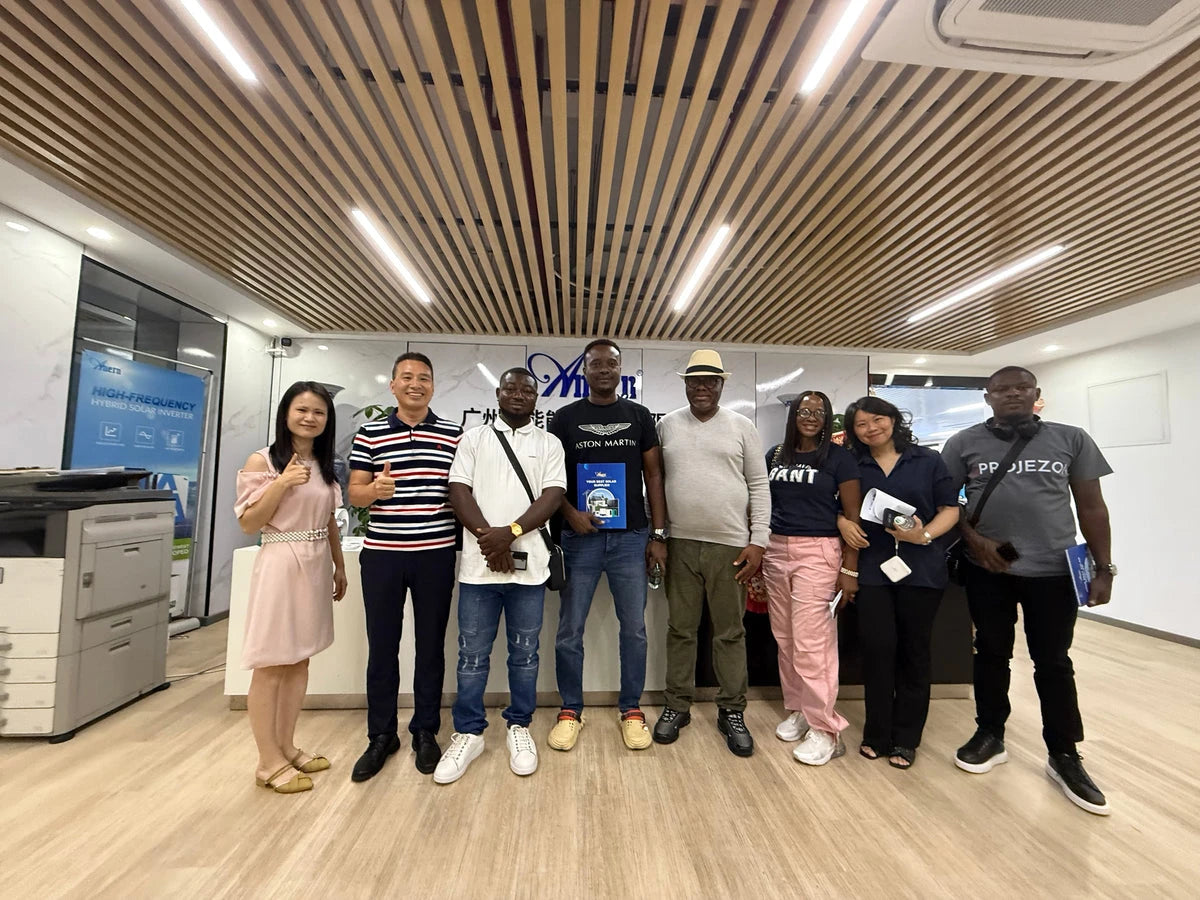 Anern team and visiting partners standing together in an energy storage showroom